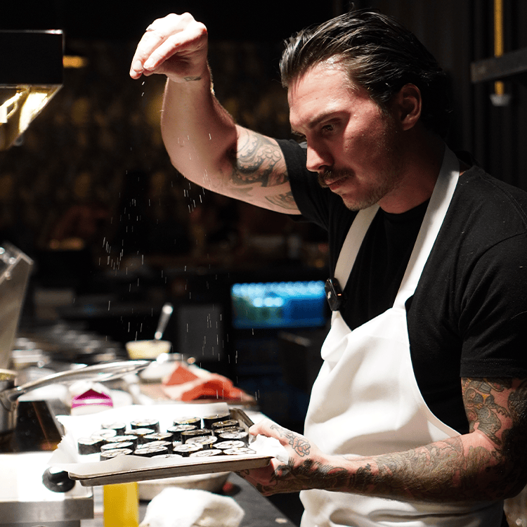 chef matt prepareing food for chef's table at vice & virtue brewing kelowna